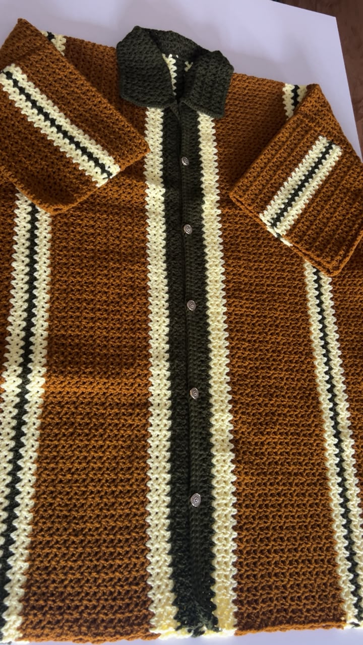 Flat lay of men's striped crochet polo — detailed stitchwork